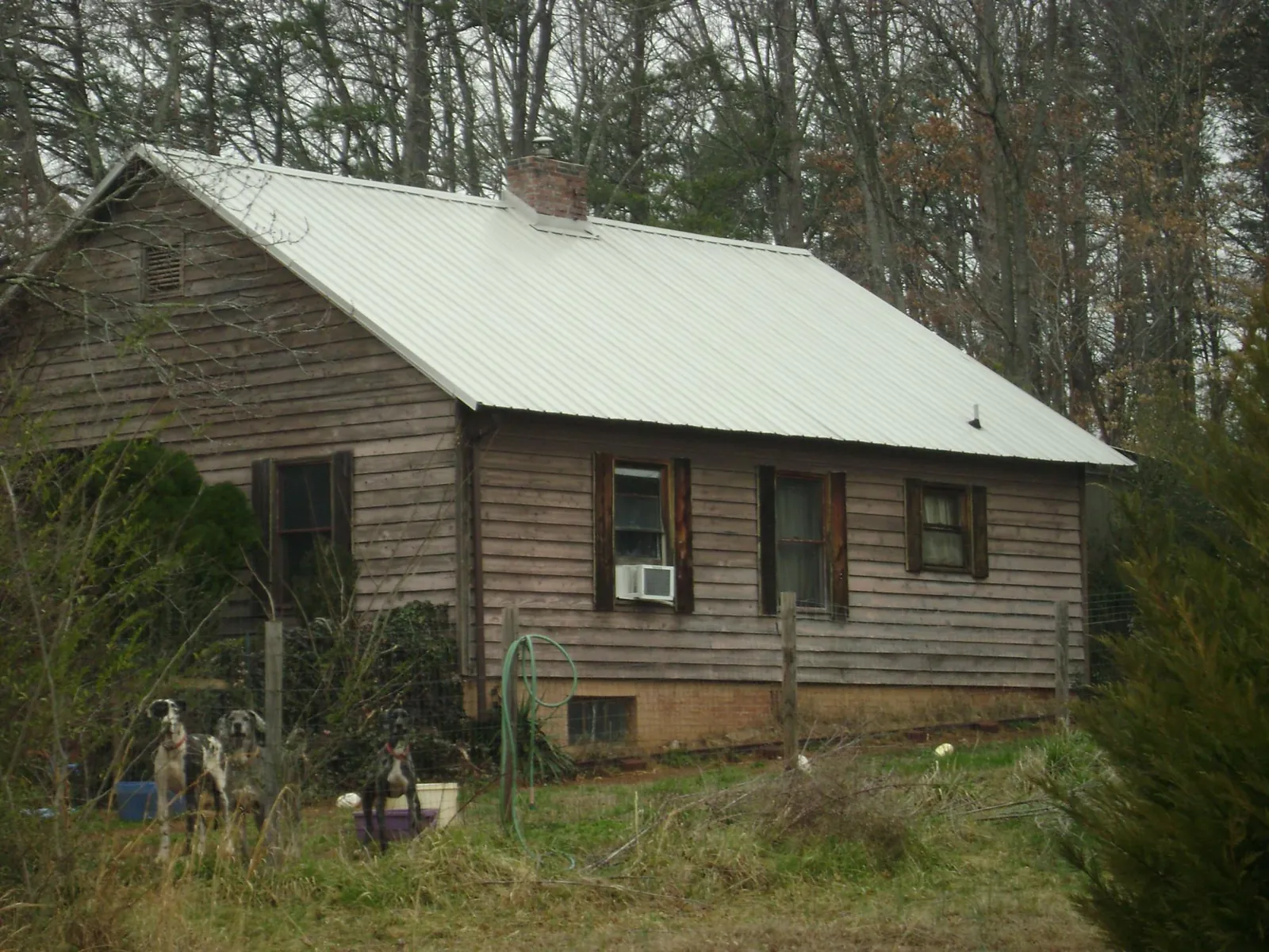 White metal roof on an old wood sided farmhouse, from a Metal Roof Installation job in Linden
